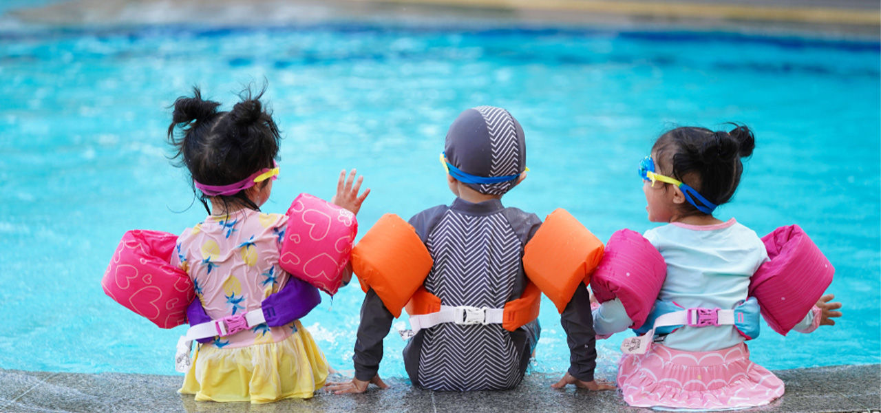 kids at swimming pool with floaties