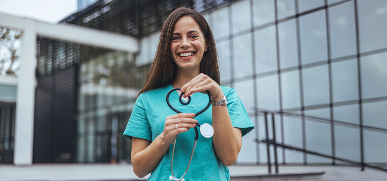 woman in scrubs with heart shaped stethoscope